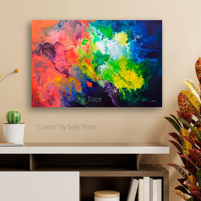 Colorful abstract painting print titled 'Comet' by Sally Trace on a beige wall above a white shelf.